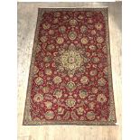 A Persian Zielger type rug, hand knotted, the red ground with interlaced foliate and chrysanthemum