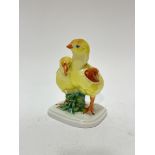 A Herend Hungarian porcelain figure group of two young chicks decorated with polychrome enamels, (