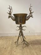 A large white metal free standing ice bucket with twin stylised stag head handles and antler