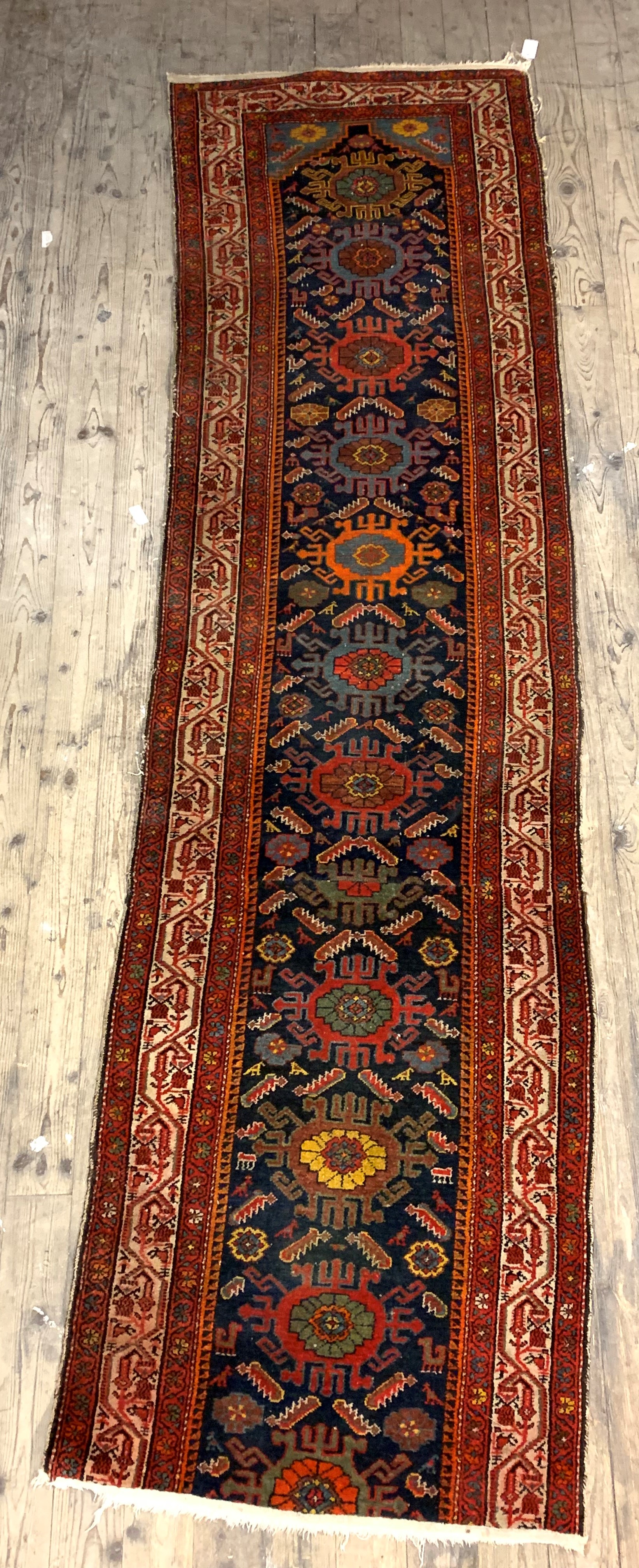 A Persian runner rug, hand knotted, the blue field framed within a guarded border (cut) 340cm x