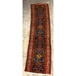 A Persian runner rug, hand knotted, the blue field framed within a guarded border (cut) 340cm x