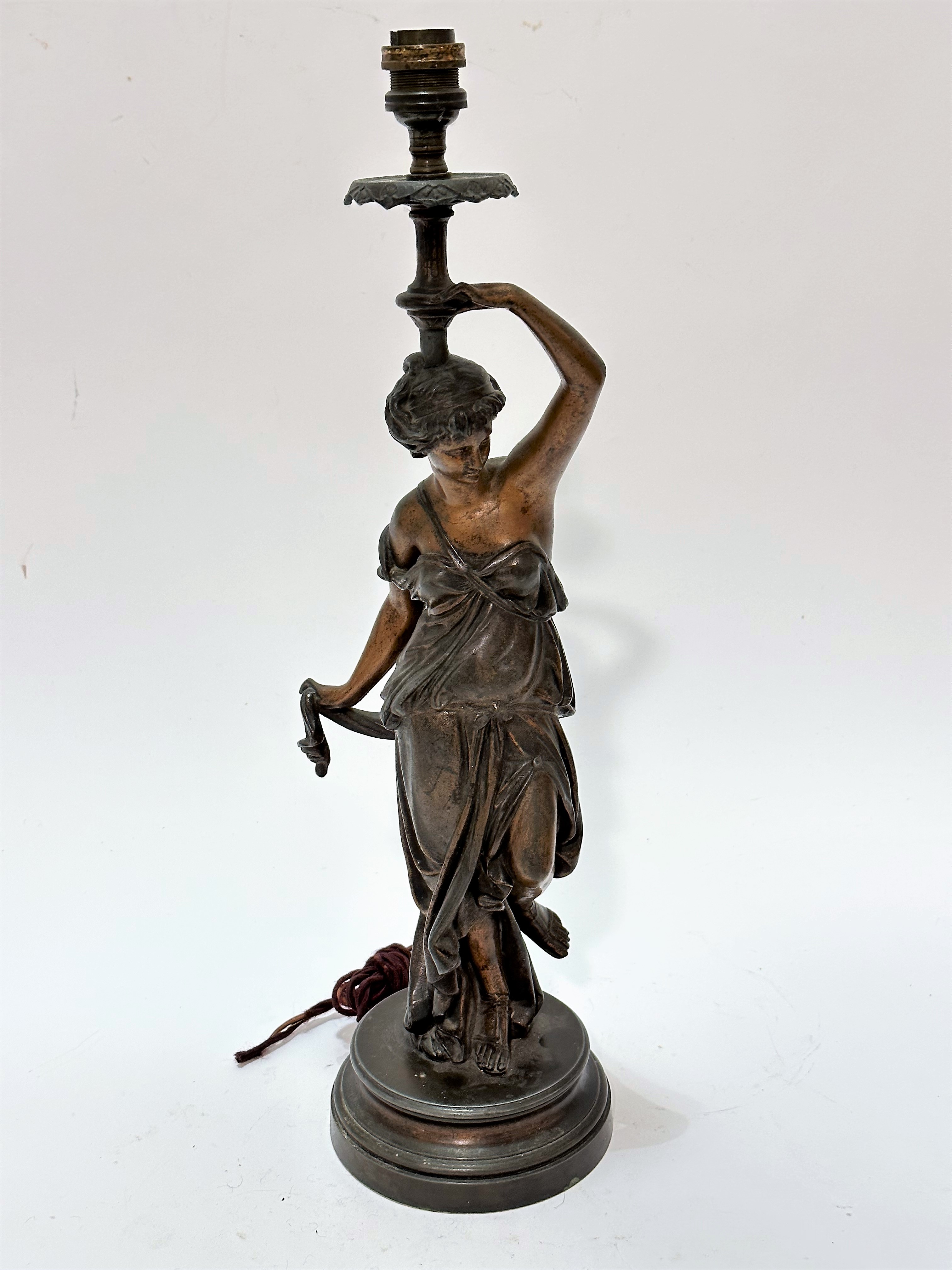 A French cast spelter figure lamp of a young lady draped in Grecian style, on circular moulded base,