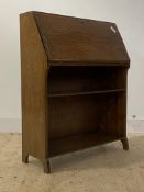 An early 20th century oak bureau, the fall front revealing fitted interior over open shelves, raised