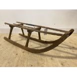 A Vintage dry hardwood toboggan type sledge L117cm (traces of old woodworm)