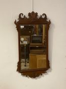 A Georgian style mahogany fret cut wall mirror carved with Prince of Wales feathers over bevelled