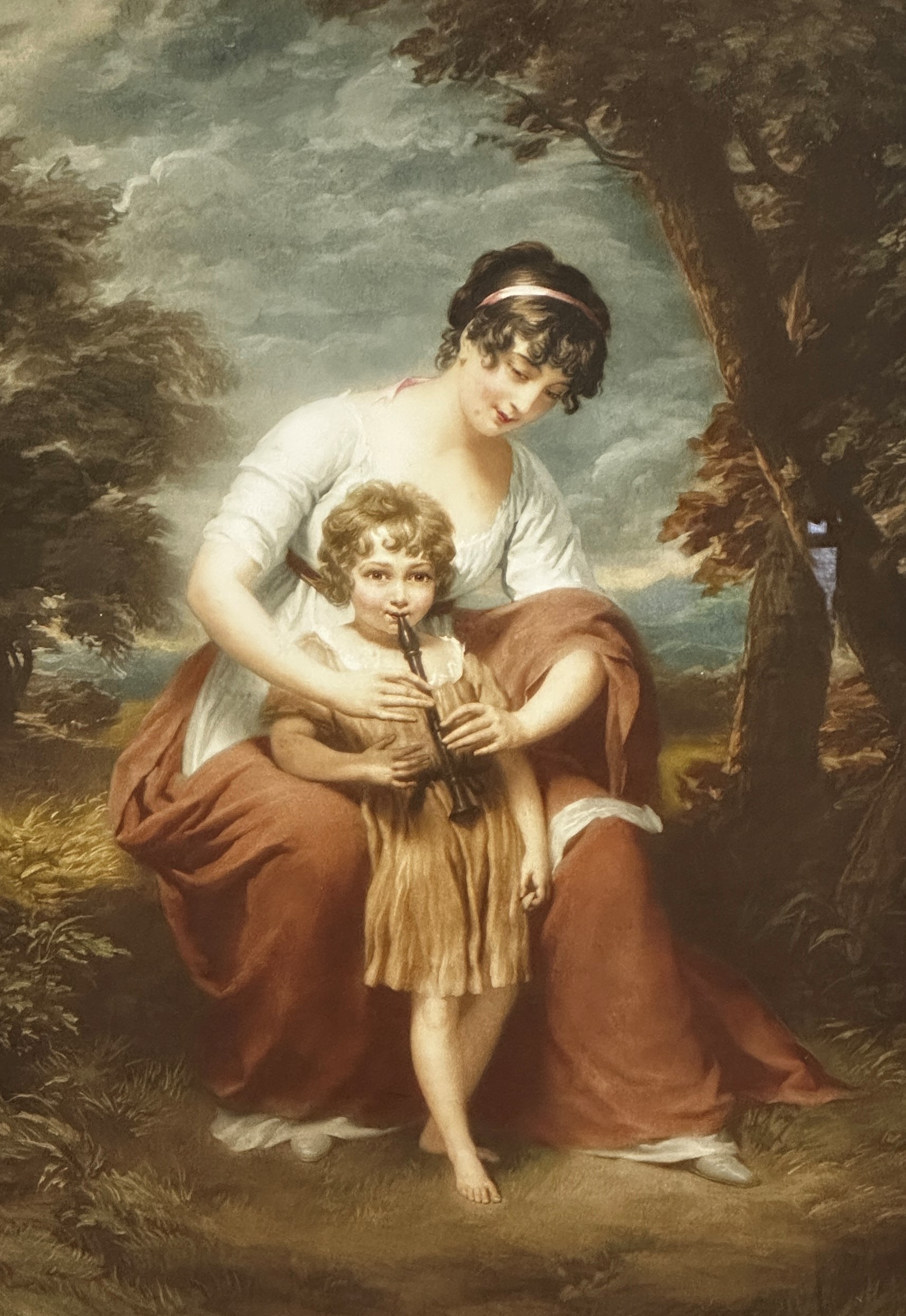 A reproduction lithographic print of a mother and child playing the recorder, signed bottom right,