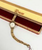 A lady's Timor 9ct gold wrist watch on 9ct gold adjustable flexible bracelet with champagne dial and