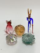 A collection of paperweights including a clear glass millifiori cane paperweight (5cm x 6cm)