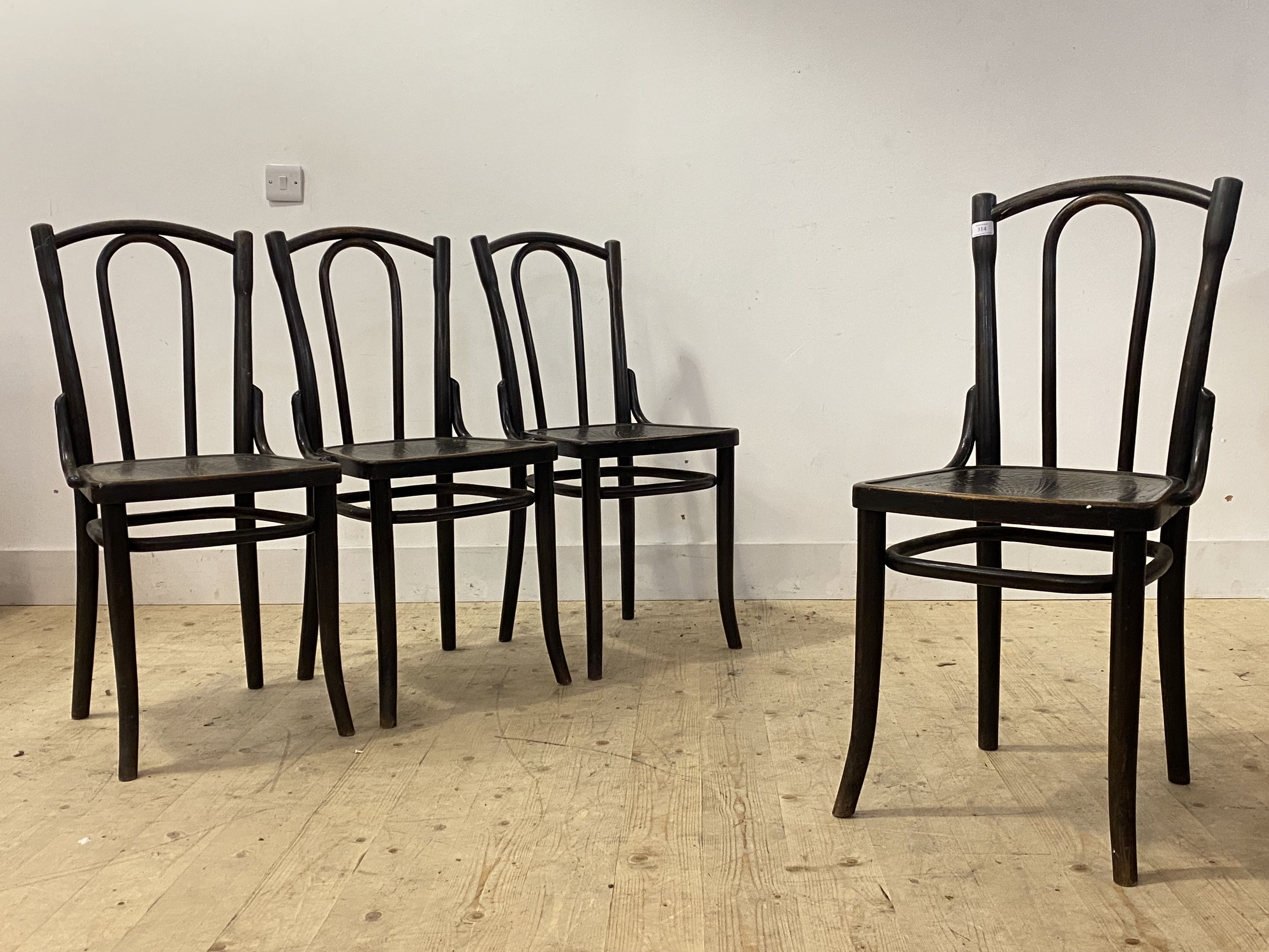 A set of four ebonised bentwood chairs by Thonet, each with paper label (Some losses) and stamped