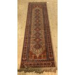 A Persian style runner rug with lozenge pole medallion 285cm x 69cm
