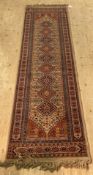 A Persian style runner rug with lozenge pole medallion 285cm x 69cm