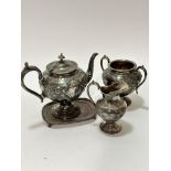 A Britannia metal three piece tea service including a baluster tea pot with C scroll handle and