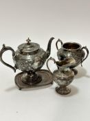 A Britannia metal three piece tea service including a baluster tea pot with C scroll handle and