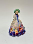 A Royal Doulton china figure Easter Day, HN2039, signed TM, (h 20cm x 14cm x 12cm) decorated with