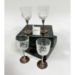 Two pairs of crystal slice cut red wine glasses mounted on Epns stems and circular bases with beaded