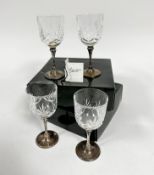 Two pairs of crystal slice cut red wine glasses mounted on Epns stems and circular bases with beaded
