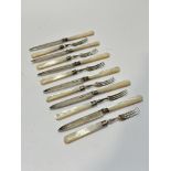 A set of six Sheffield silver bladed and mother of pearl handled Edwardian fruit knives and forks (L