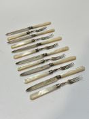 A set of six Sheffield silver bladed and mother of pearl handled Edwardian fruit knives and forks (L