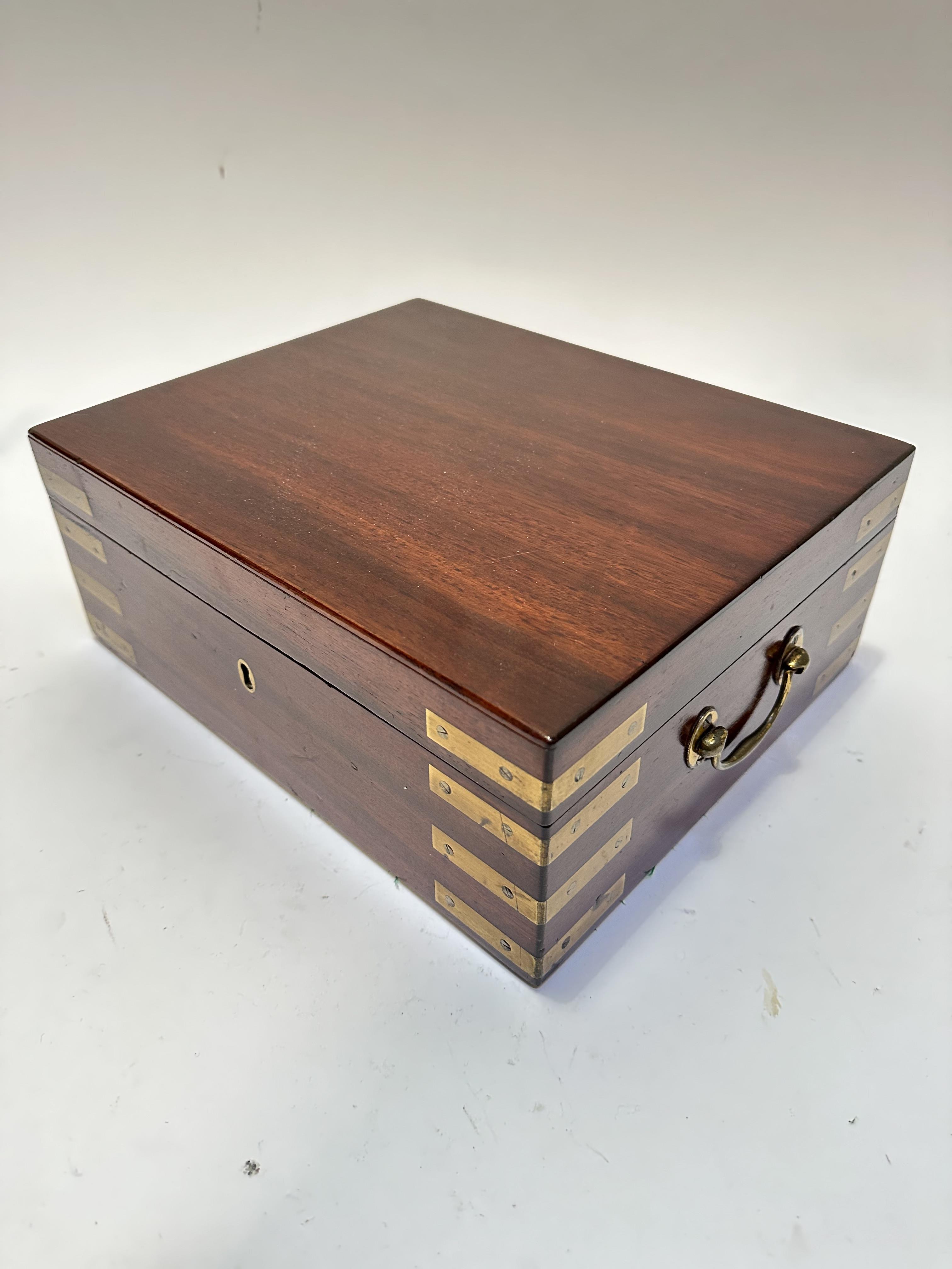 A 19thc mahogany brass mounted rectangular box with brass carry handles to side, no key, (12cm x