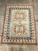 A hand knotted Turkish rug, sage green field with double medallion and geometric motif to border