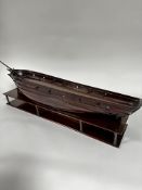 A 19thc mahogany model of a sailing vessel in the 18thc style, missing masts, complete with hardwood