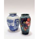 A William Moorcroft baluster vase decorated with anemone design, graduated blue ground, small chip