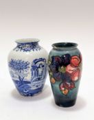 A William Moorcroft baluster vase decorated with anemone design, graduated blue ground, small chip