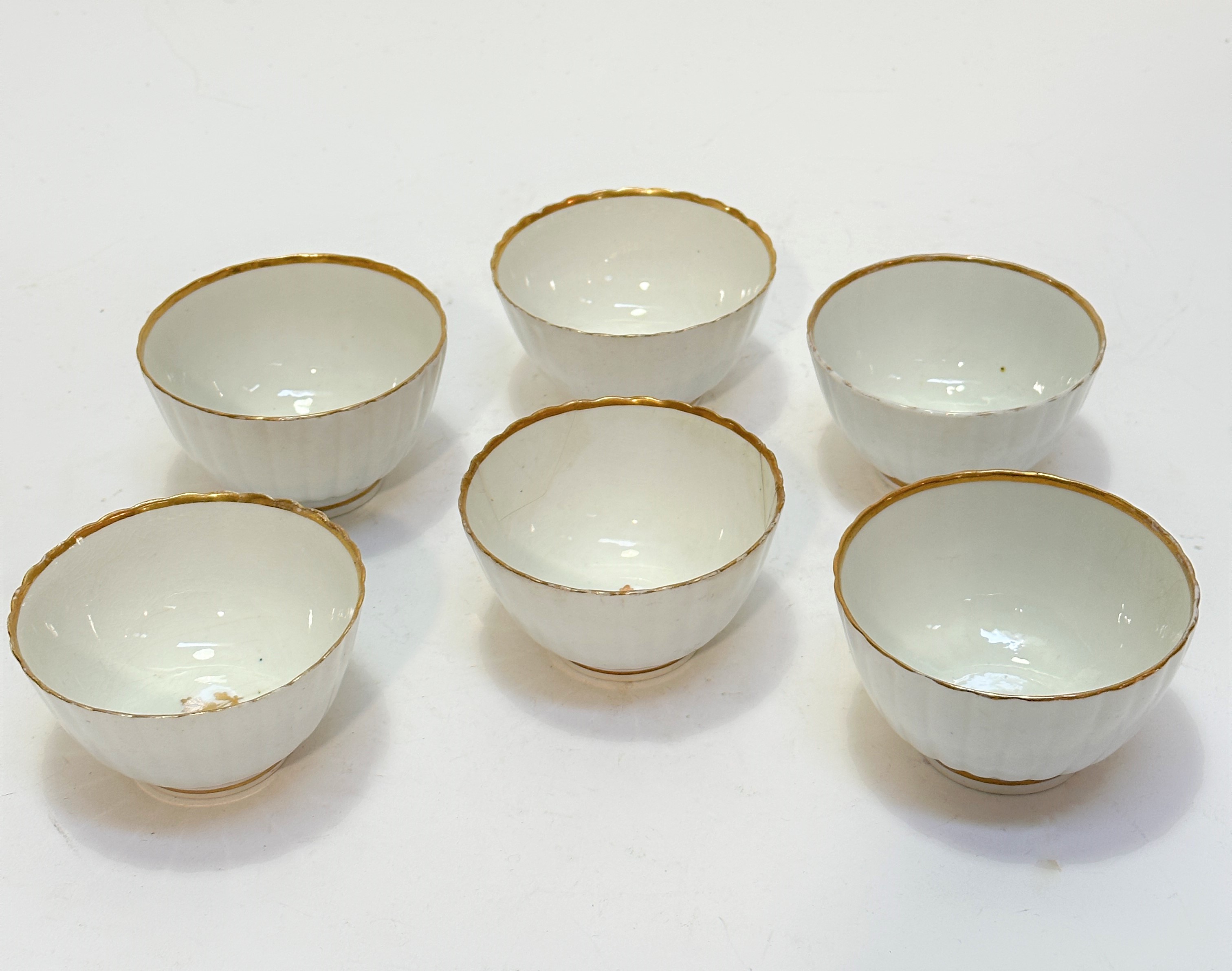 A set of six 19thc English china fluted tapered tea bowls with gilt lips and internal floral gilt