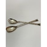 A pair of Elkington & Co Birmingham silver scroll terminal salad servers, of tapered form,