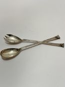 A pair of Elkington & Co Birmingham silver scroll terminal salad servers, of tapered form,