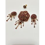 A late 19th early 20thc garnet cluster brooch with centre cluster and swags with drops, some