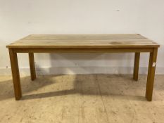 A Contemporary solid oak dining table, on square section supports H76cm, 180cm x 90cm