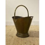 A 19th century brass coal bucket with swing handle and moulded base H34cm