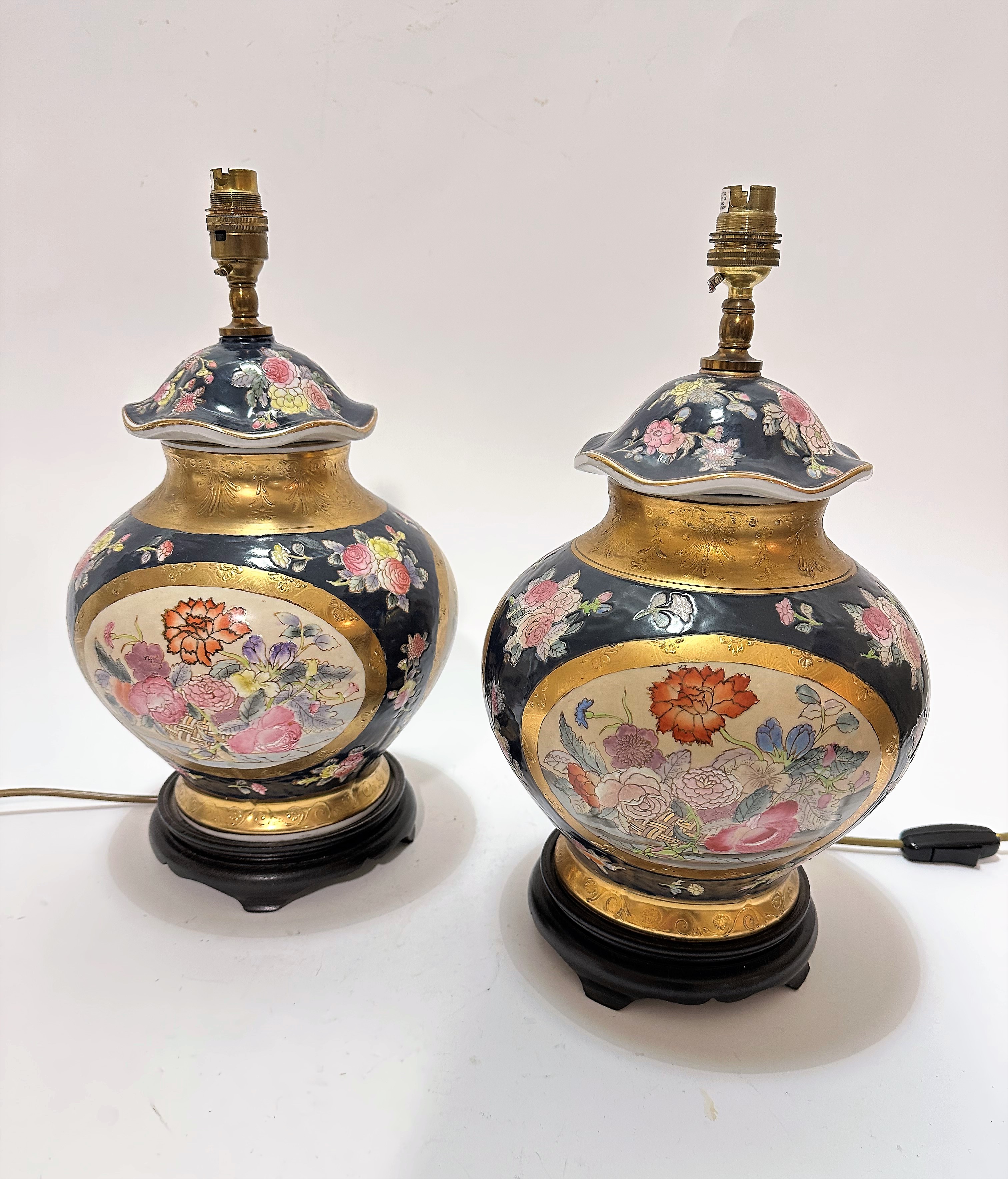 A pair of Japanese baluster vase table lamps with scalloped tops above an oval centre panel with