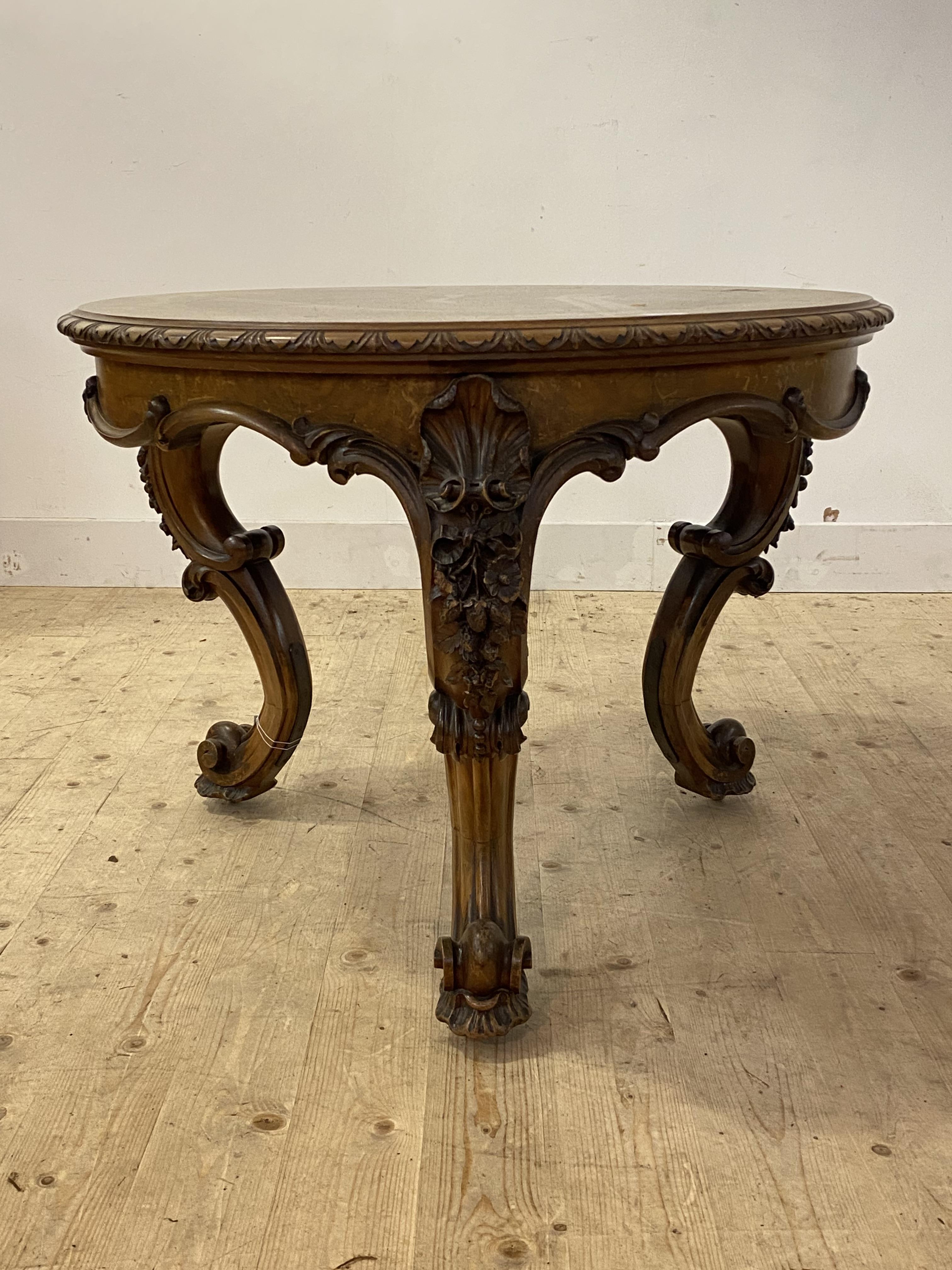 A Victorian walnut centre table, the quarter sawn and cross banded circular top with moulded