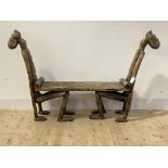 An unusual African stinkwood hall bench formed as two crouching figures supporting a plank seat