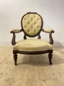 A Victorian walnut framed upholstered salon chair, with floral carving and moving on later
