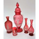 An Edwardian cranberry glass Mary Gregory style decorated baluster vase complete with domed cover