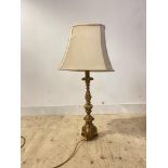 A gilt composition table light in the form of a candle stick, H72cm