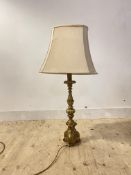 A gilt composition table light in the form of a candle stick, H72cm