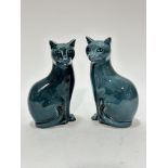 A pair of Poole pottery green / blue seated cats with black tipped tails, (17cm x 10cm x 6cm)