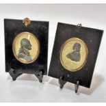 A pair of early 19thc ebonised portrait miniature frames with prints depicting George Washington and