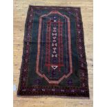 A hand knotted new baluchi rug, the black field with stylised floral design, guarded border 155cm