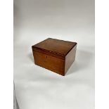 An Edwardian mahogany box, the rectangular top with moulded edge enclosing a plain interior, (18cm x