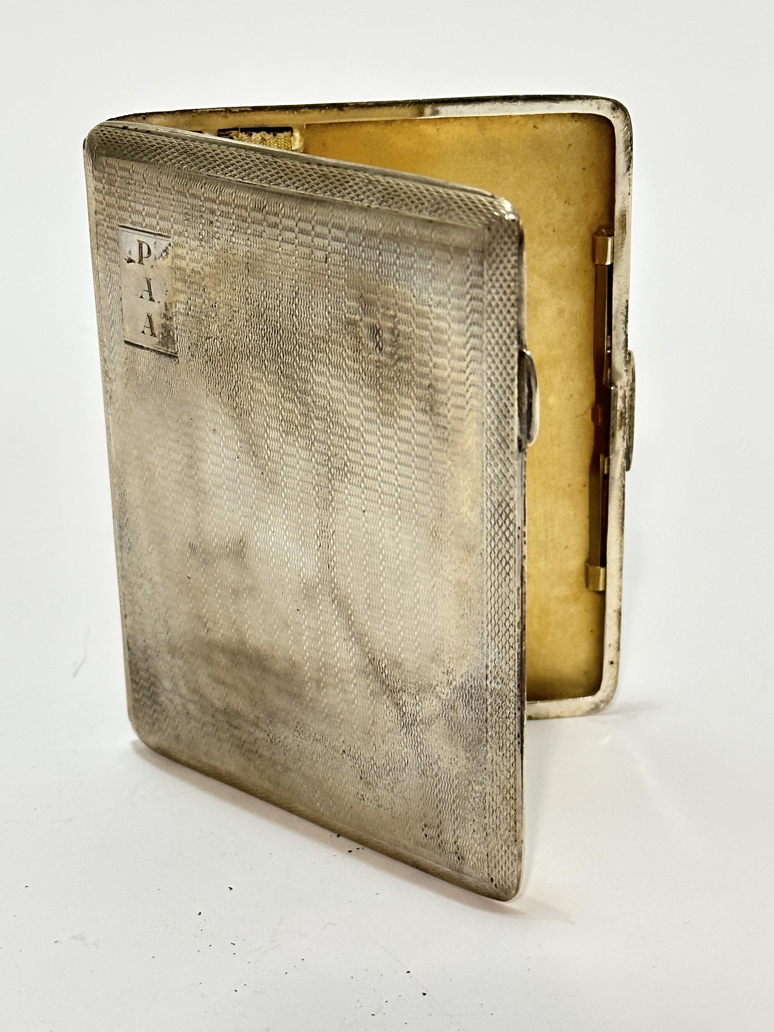 An Edwardian Birmingham silver engine turned decorated cigarette case with engraved initials PAA and