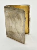 An Edwardian Birmingham silver engine turned decorated cigarette case with engraved initials PAA and