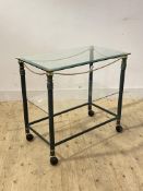 A Hollywood Regency style patinated metal and gilt brass drinks trolley, the plate glass top over a