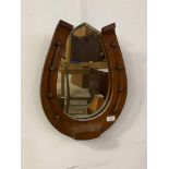 A walnut framed wall hanging mirror in the form of a horse shoe, 38cm x 48cm