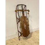 A Vintage Flexible flyer stained and painted oak and cast iron articulated sledge, L112cm