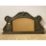 An Art Nouveau period patinated cast metal over mantel mirror frame, the scrolling frame typically